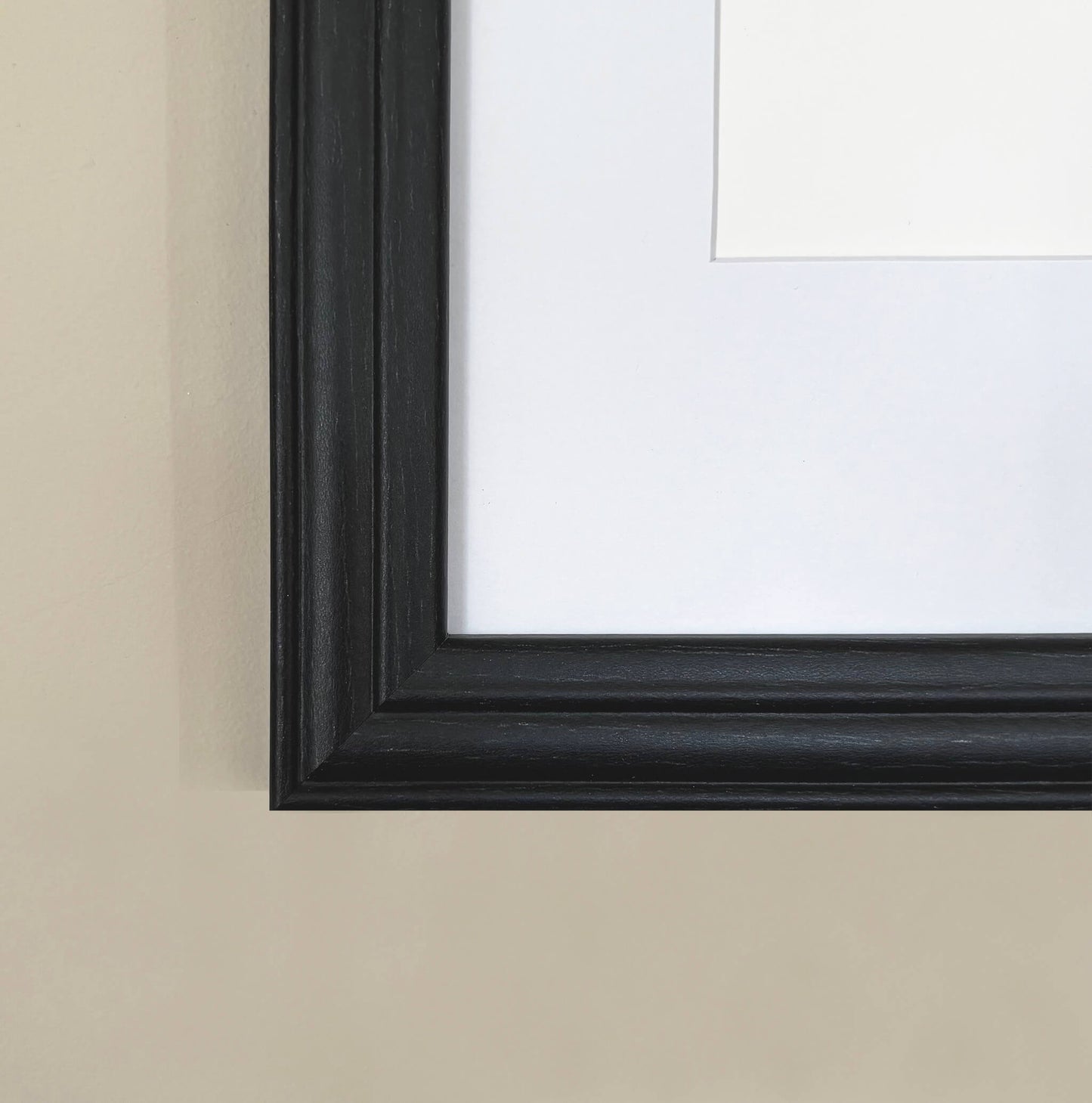 Black picture frame on a beige wall