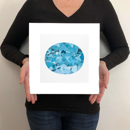 A giclée fine art print of an Aquamarine gemstone on a light stone background. This image illustrates the print size.