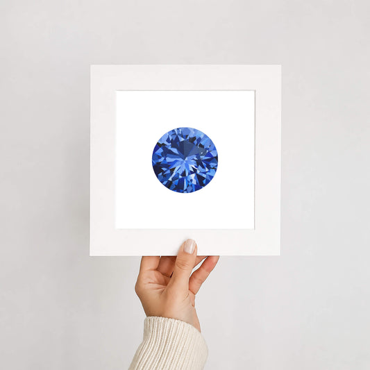 Hand holding a card with a blue gemstone on a light gray background