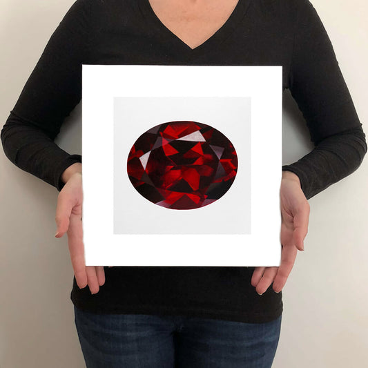 A giclée fine art print of a garnet gemstone on a light stone background. This image illustrates the print size.