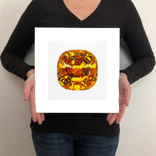 A giclée fine art print of a yellow topaz gemstone on a pale stone background. This image illustrates the print size.