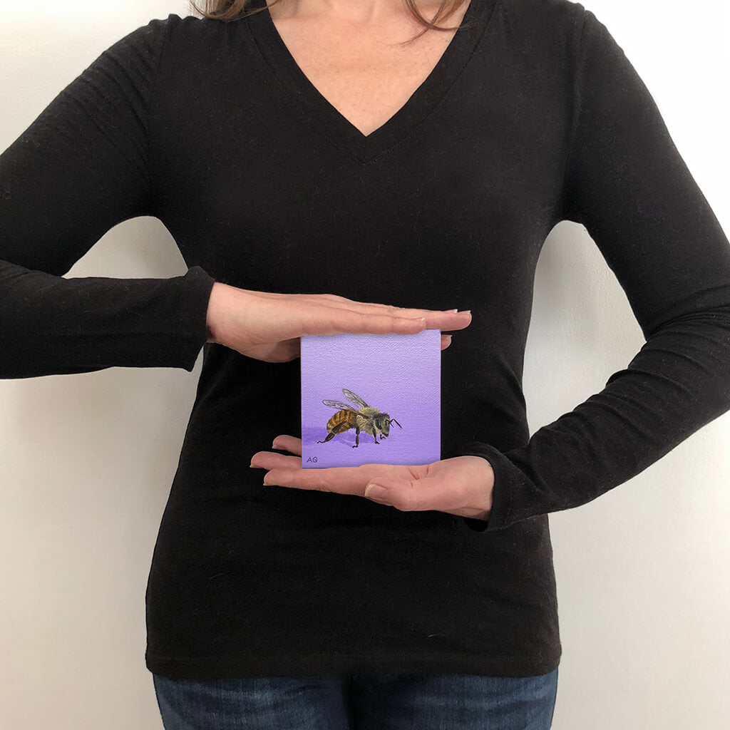 Amanda Gosse Miniature Painting of a honey bee on a purple background