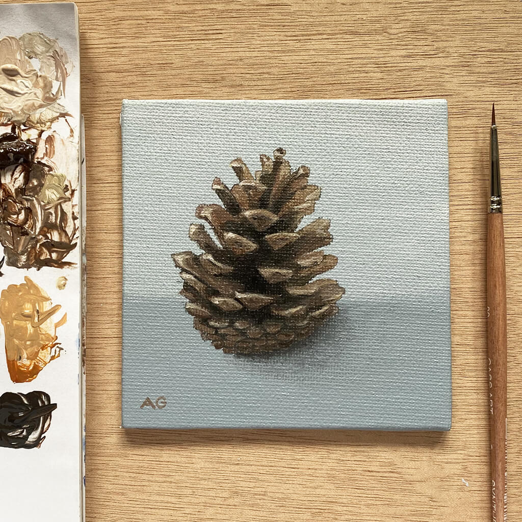 Amanda Gosse artist easel with miniature painting of a pine cone