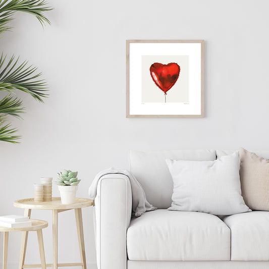 A giclée fine art print on paper of a heart shaped red helium balloon on a light grey background. This image illustrates the print size.