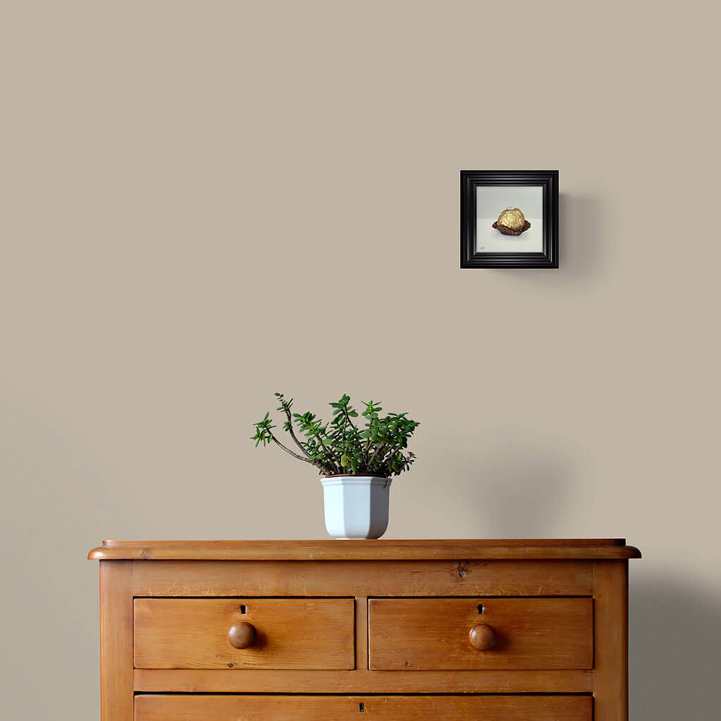 Chocolate in gold foil original painting in black frame in room setting by Amanda Gosse in room setting