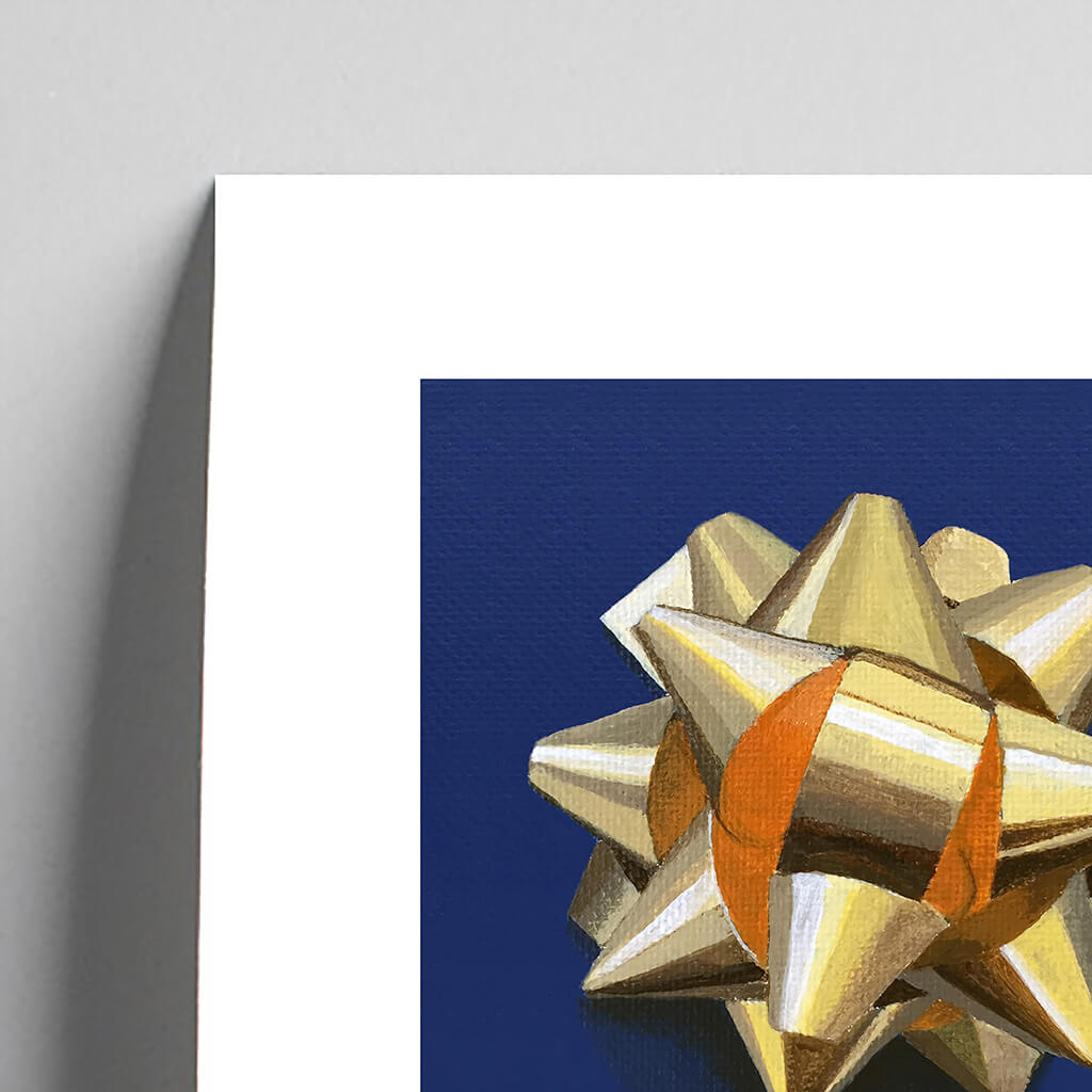 Detail of giclée fine art print of a gold gift bow on a cobalt blue background.