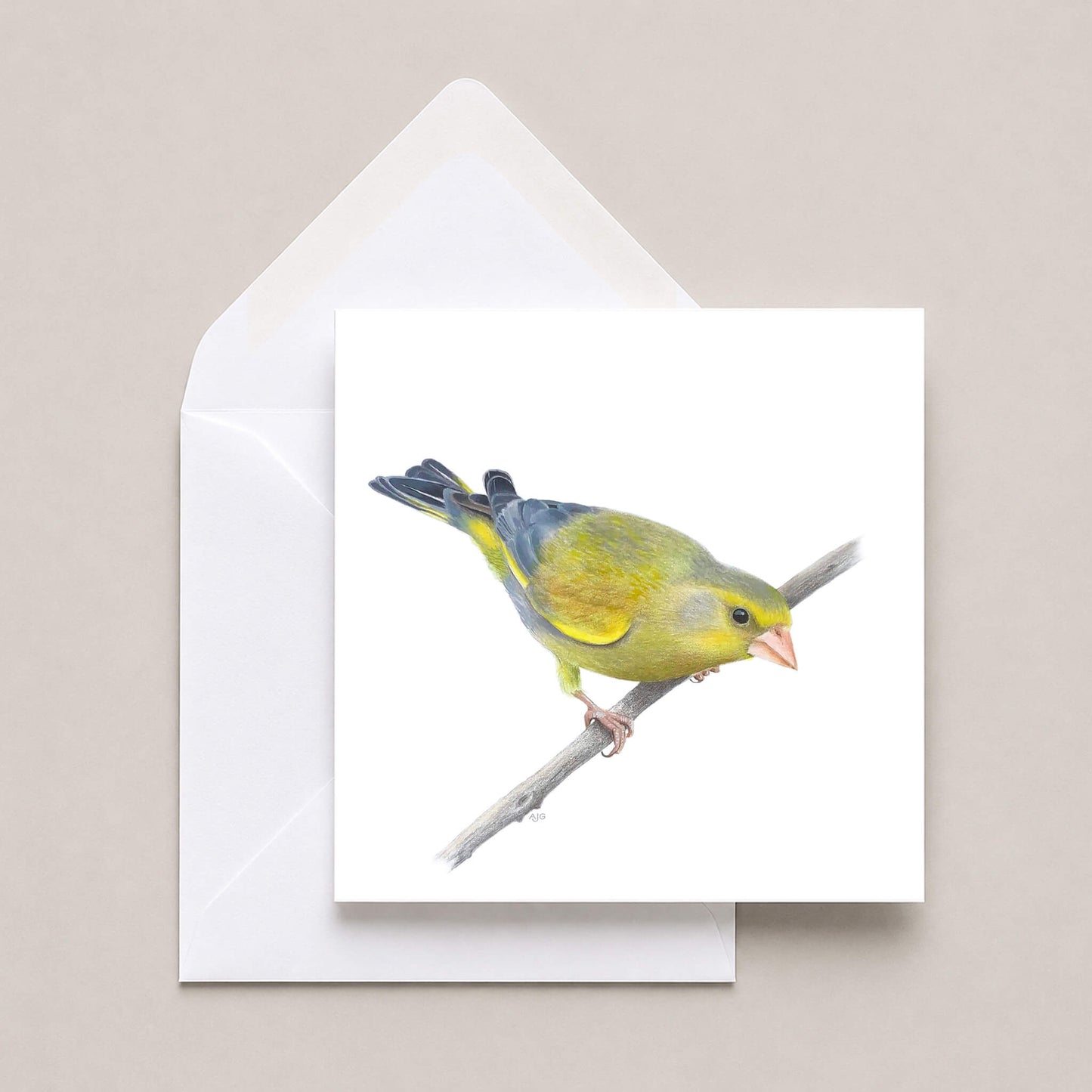 A square white greeting card featuring a painted greenfinch bird perched on a branch, shown with a white envelope on a light beige background.