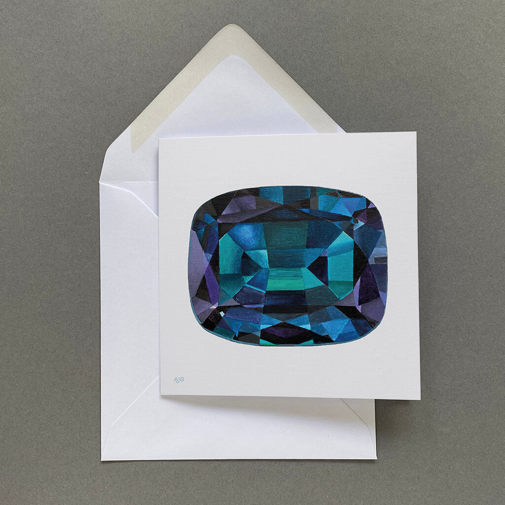 Greeting card with a blue and purple alexandrite gemstone design on a pale grey background