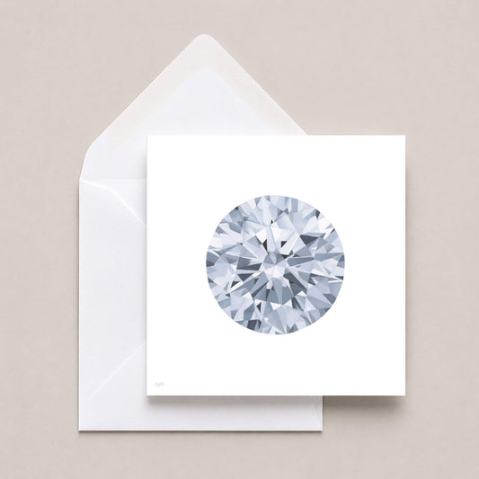 A square white card featuring a detailed faceted circular diamond illustration, shown with a white envelope on a light beige background.