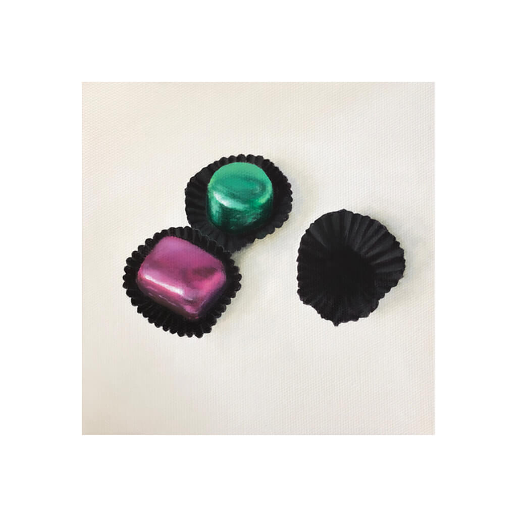 A giclée fine art print of green and purple foil wrapped chocolates, against a pale neutral colour background.