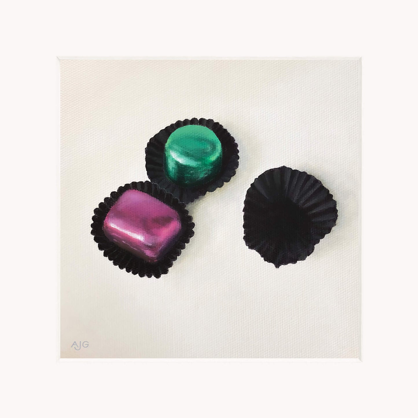 Giclée print in mount of three colourful chocolates in black casings on a white background