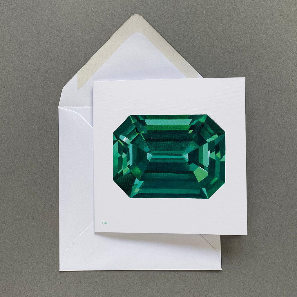 Card with a green gemstone design on a grey background