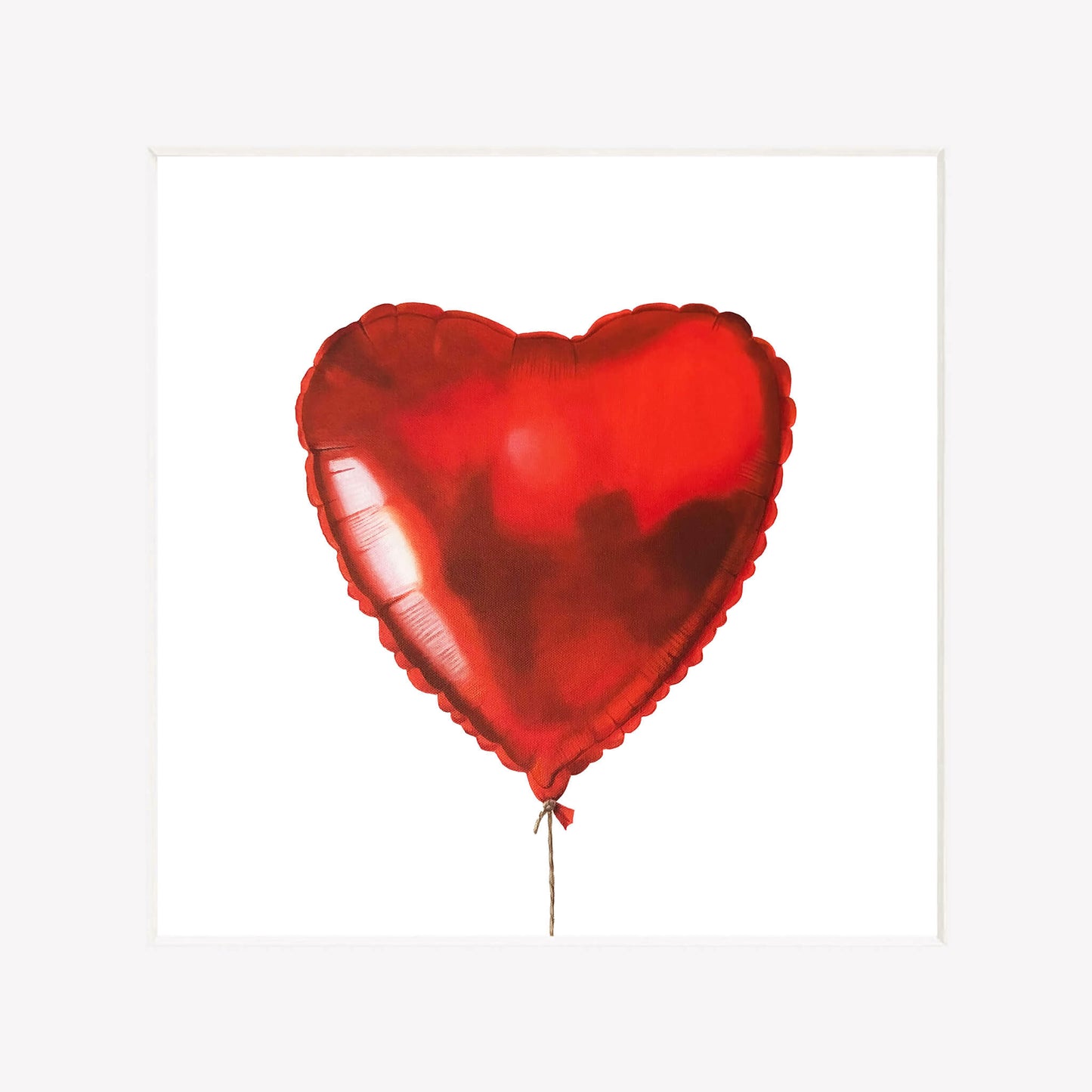 Red heart-shaped balloon on a white background