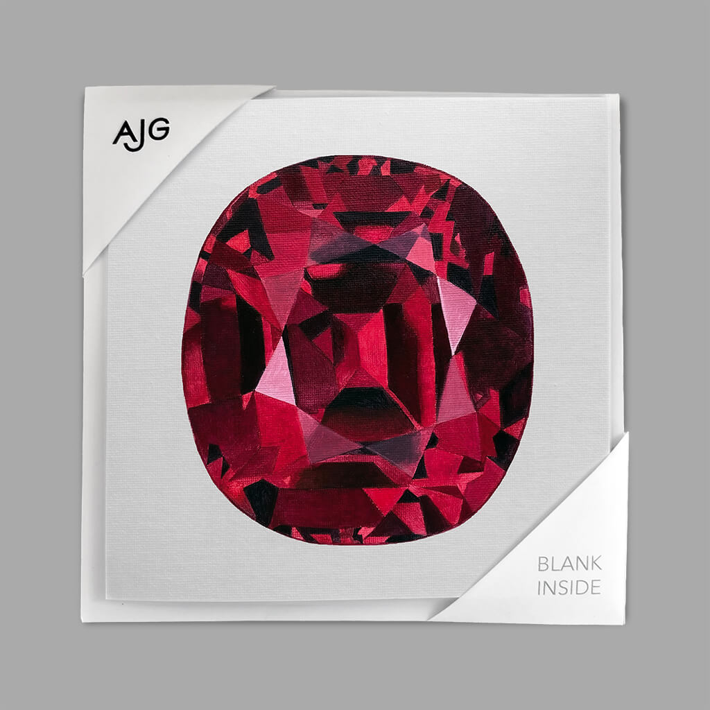 Card with a red gemstone design on a pale grey background with AJG logo