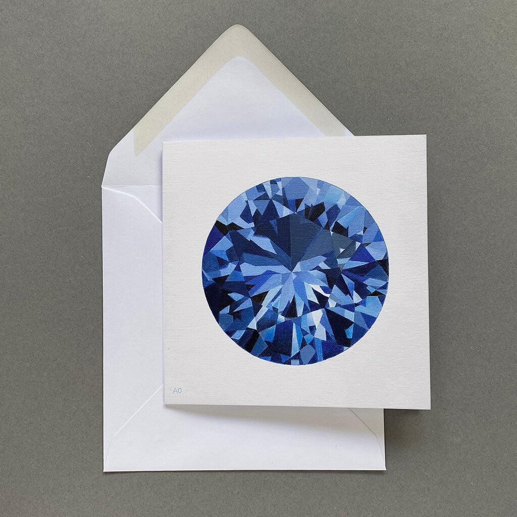 Greetings card with a blue sapphire gemstone design on a light grey background