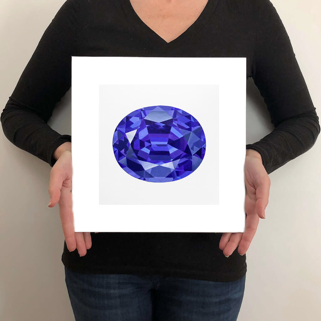 A giclée fine art print of a Tanzanite gemstone on a very pale stone background. This image illustrates the print size.